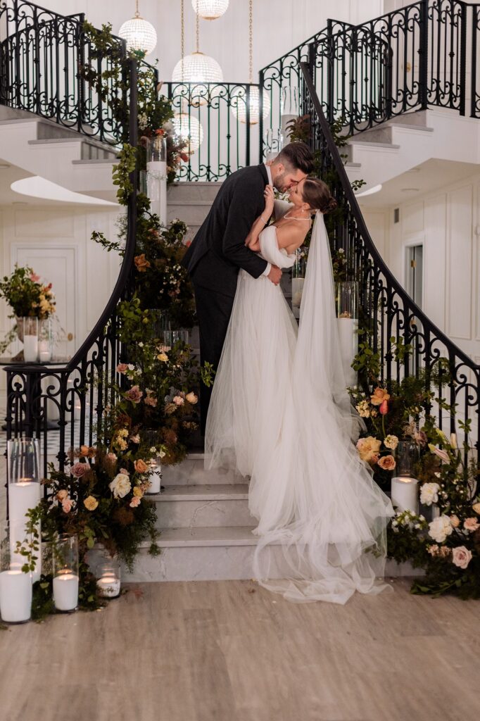 Bride and groom on Archway Manor grand staircase
