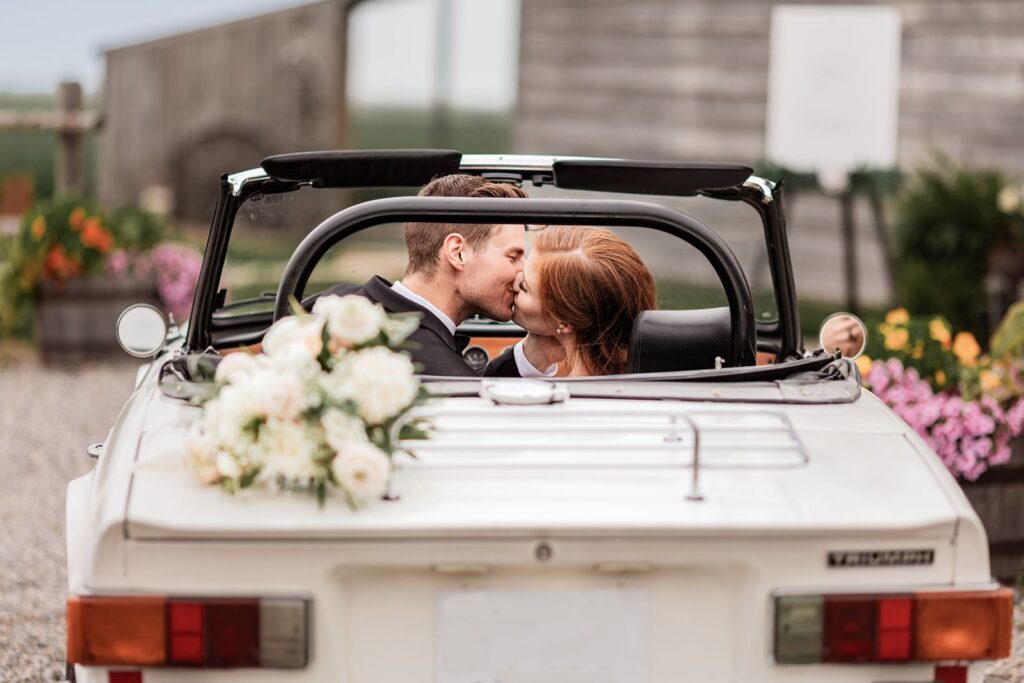 Calgary wedding photographer photograph of a bride and groom in a vintage car