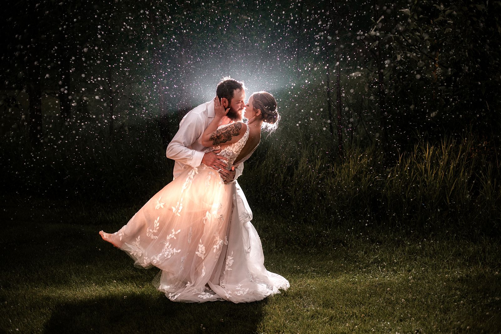 calgary wedding photographer photograph of a bride and groom leaning in for a kiss in the rain