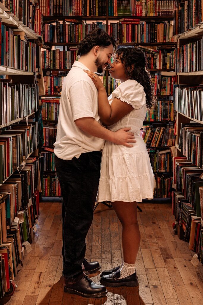 Couple cozying up in a bookstore aisle