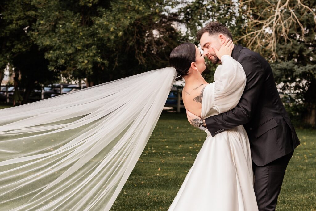 Bride and groom portrait on a lawn