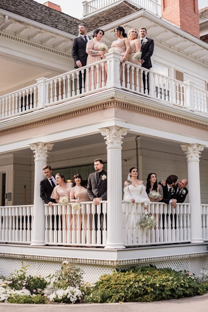 Wedding party posing on the two balconies of the wedding venue