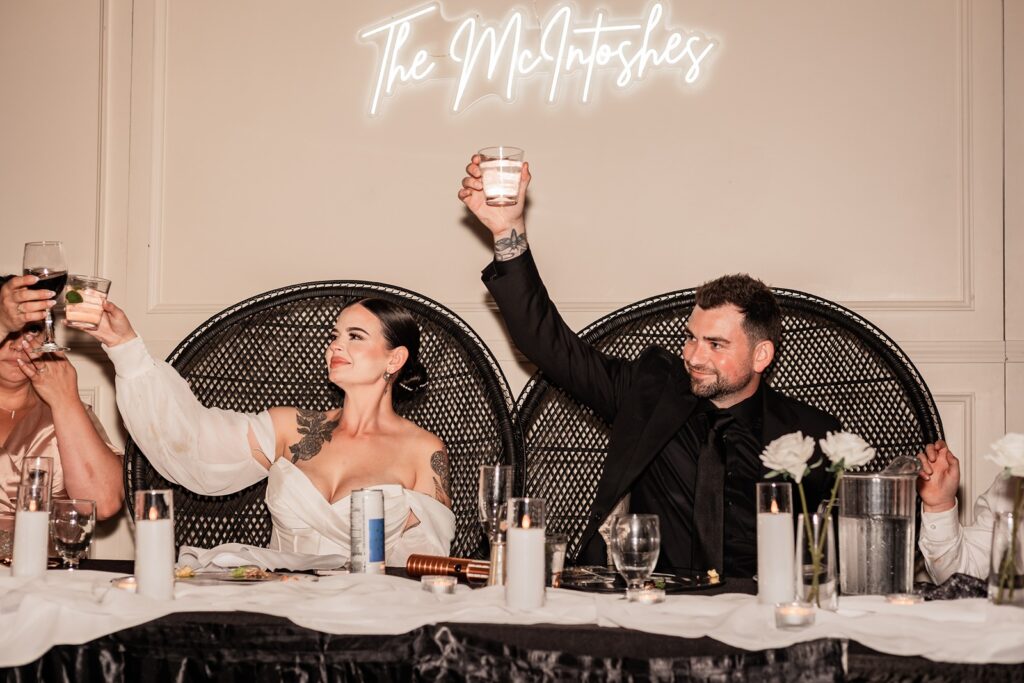 Bride and groom doing a cheers during their wedding reception