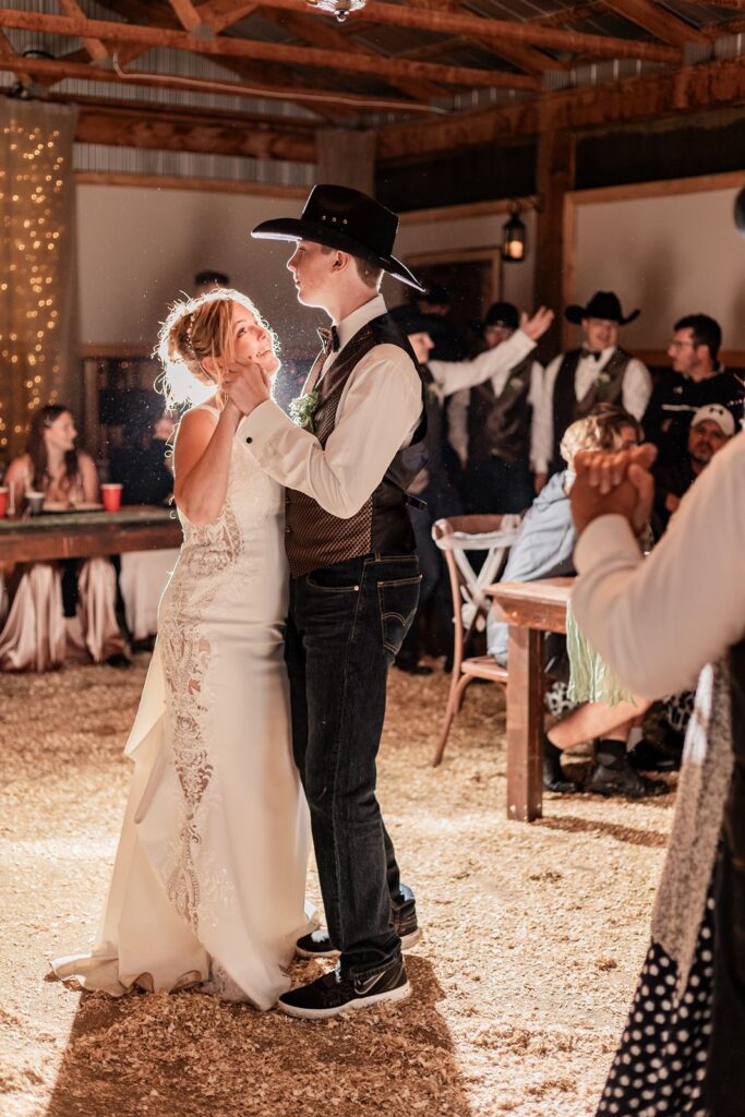Bride smiling at her son during their dance