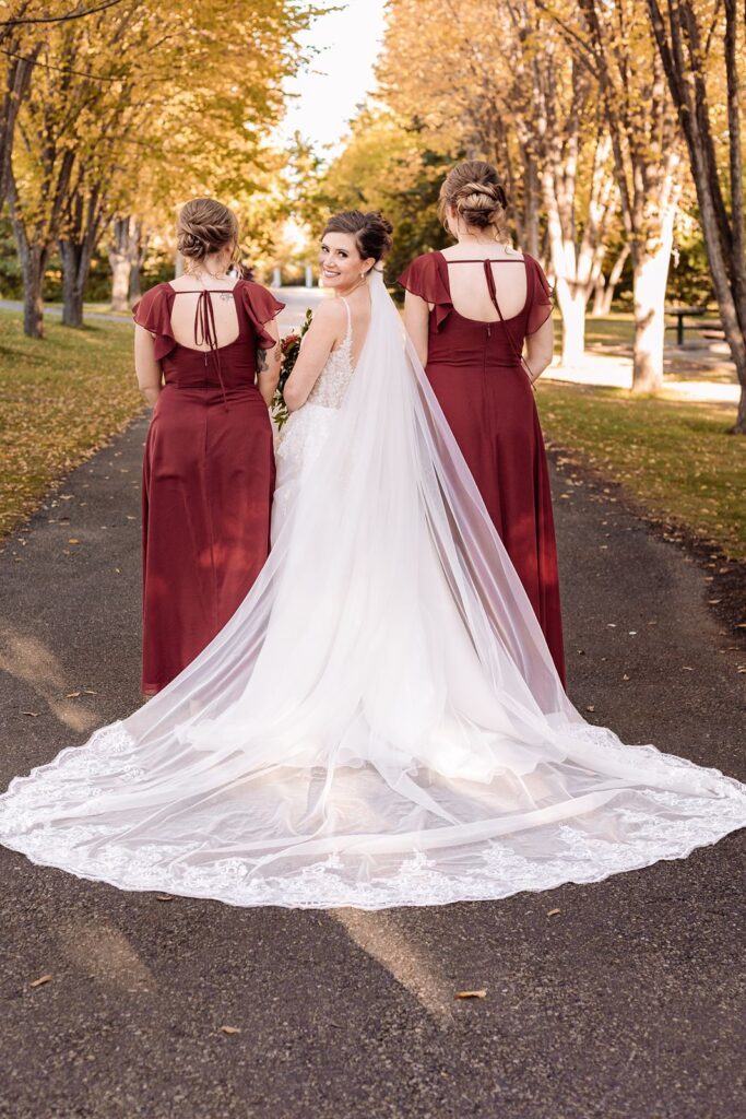 Bride looks over her shoulder with her bridesmaids beside her