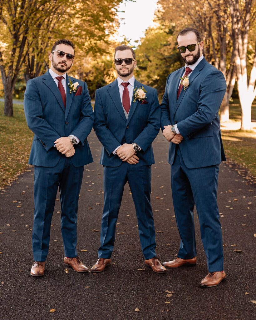 Groom and groomsmen pose with sunglasses