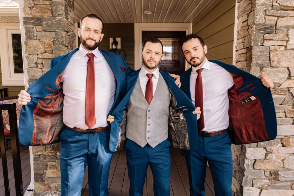 Groom with groomsmen posing before leaving the house