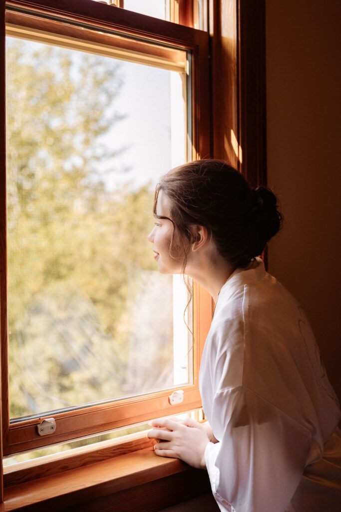 Bride looks out the window at Reader's Garden Cafe