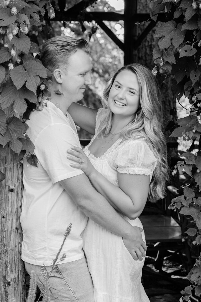 Man holds women surrounded by foliage
